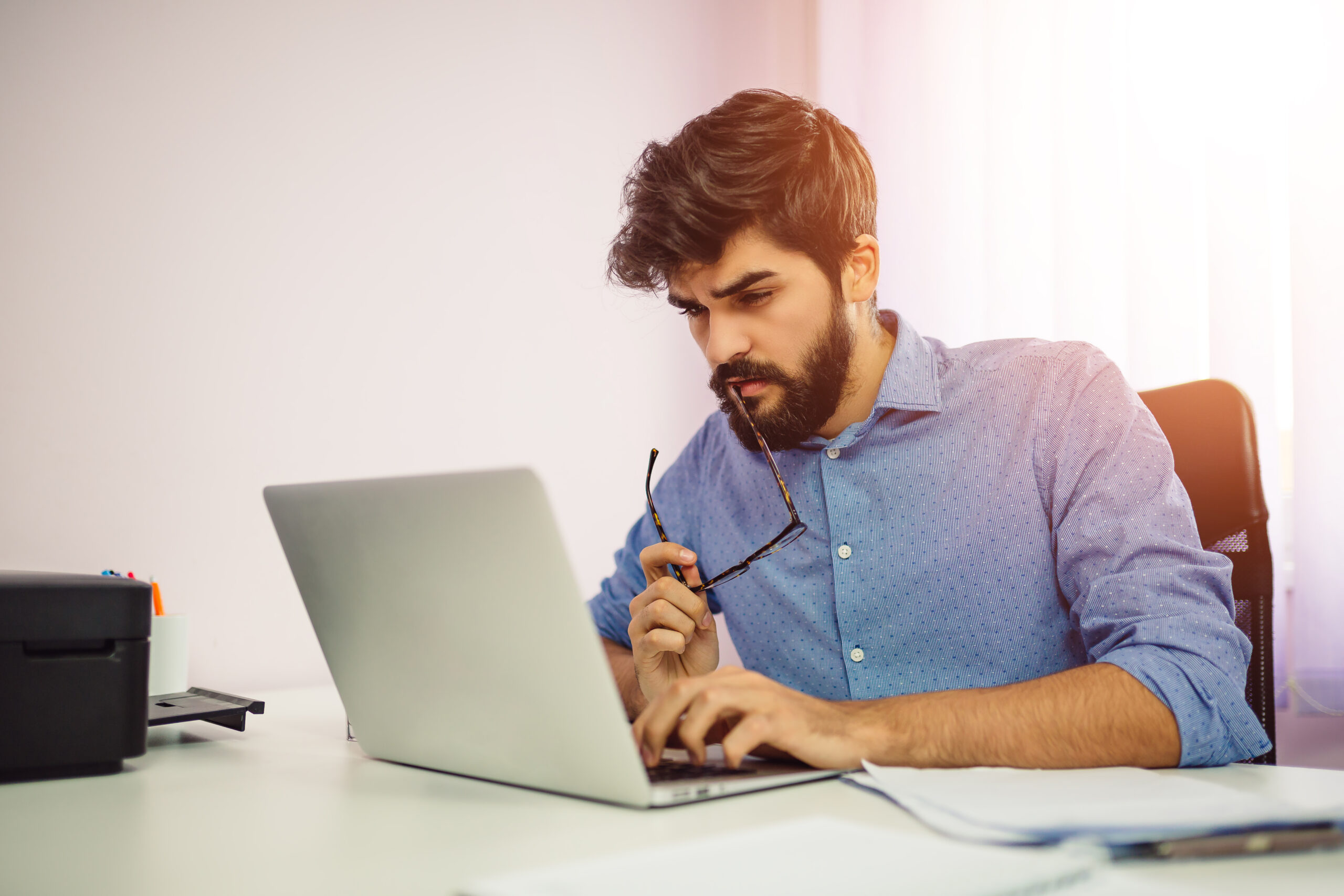 Concentrated man using laptop computer.
